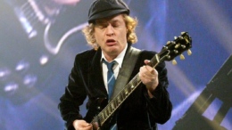 Angus Young playing guitar for AC/DC